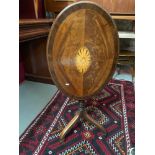 A Georgian flip top side table, Supported on a single pedestal and three curved legs. Ornate inlay