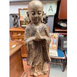 A 19th century Chinese cast iron Monk figure.Showing signs of original gold colouring coming