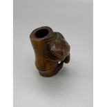 Japanese hand carved netsuke of a Frog climbing a bamboo trunk. Frog has black bead eyes and is
