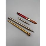 A Lot of four vintage revolving pencils which includes a rare [possibly gold] Mordan & Co highly