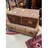 Two vintage wooden bound steamer trunks.