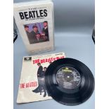 A Vintage 45 R.P.M 'The Beatles' and The Beatles VHS .