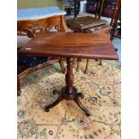 A Georgian mahogany single pedestal support, flip top card table. Ornately carved with wreath design