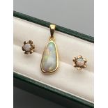 A 9ct gold and large opal stone pendant together with a pair of 9ct gold and opal stone earrings.