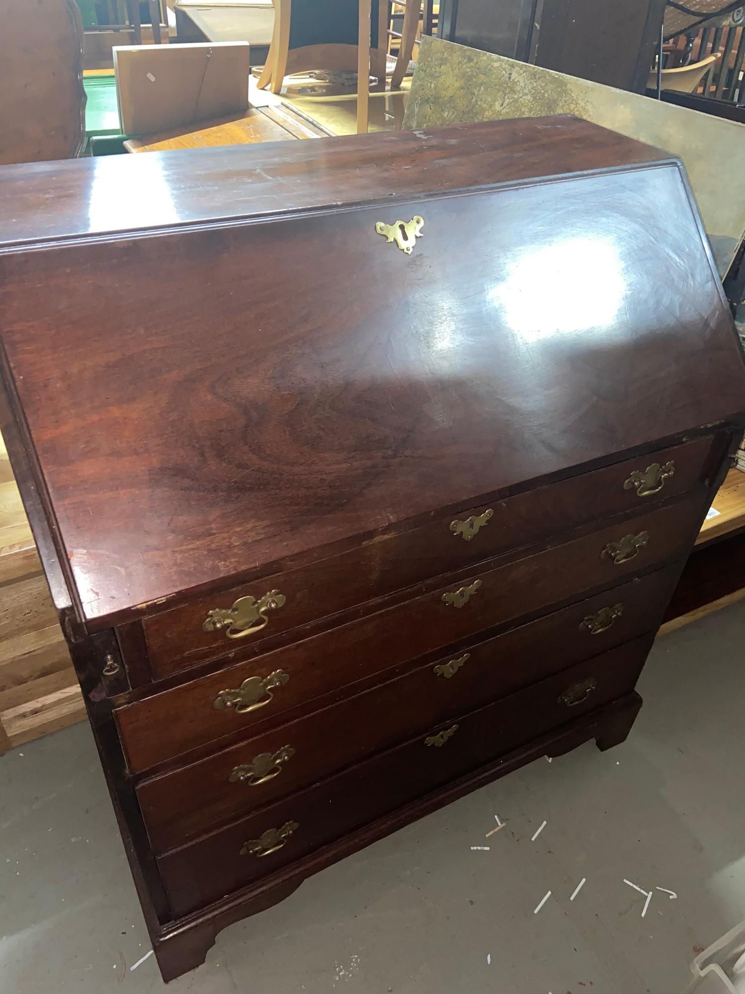 A Georgian writing bureau designed with fitted drawer interior. Comes with original brass handles.