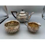 An Ornate Victorian London silver three piece tea set. Maker Josiah Williams & Co [George Maudsley