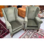 A Pair of gull wing fire side arm chairs. Supported on Queen Anne legs.