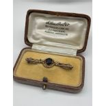 A Ladies antique 9ct gold bar brooch set with three seed pearls [one missing] and a large Amethyst