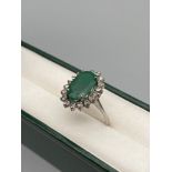 Antique Foreign white gold ladies ring set with a large emerald surround by diamonds. Stamped to the