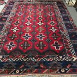 A Large antique Aztec style hand made living room rug. Measures 408x302cm