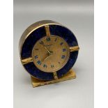 A Retro 1960's Swiza 8 day alarm clock designed with a brass body and a lapis lazuli surround. In