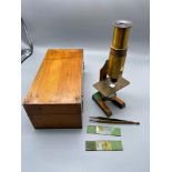 Antique portable microscope complete with wooden case.