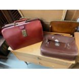 A Vintage red leather doctor style bag together with a vintage leather satchel bag.