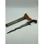 A 19th century Kris or Keris dagger with silver ornate sheath. Handle is made of wood and silver