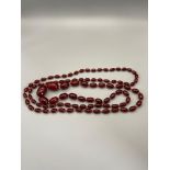 An antique Cherry Amber Graduating bead necklace. [92 oval beads] string is knotted, overall