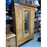 An Antique light wood double wardrobe with single mirror door. Has a single under drawer. [