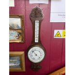 Antique wall barometer and thermometer. Designed in a dark oak case. Enamel white face and