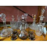 A Lot of vintage and antique cut crystal and glass decanters which includes smoked glass whisky