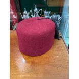 A Vintage red velvet fez hat, Stamped with military marks and dated 1957. Size 6 1/2.
