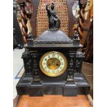 A Victorian slate mantel clock designed with metal trims, figures and Britannia figurine to the top.