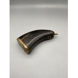 A 18th/ 19th century gun powder flask in the shape of a gun handle. Made from horn with brass