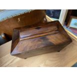 A 19th century Mahogany tea caddy, Supported on bun feet.