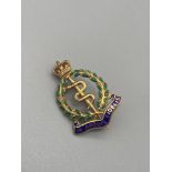 A 9ct gold and enamel Royal Army Medical Corps badge. [5.19 Grams]