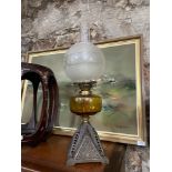 A 19th century cast metal, amber glass and frost glass shade paraffin lamp.