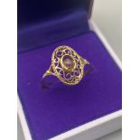 An Import London 9ct gold ladies ring in an Art Nouveau Form. Designed with a single oval cut pale