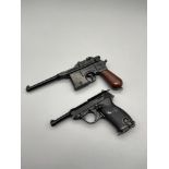 Two vintage Uniwerk Italy miniature toy pistols.