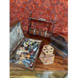 A Wooden box containing a selection of vintage smoking pipes together with three various pipe stands