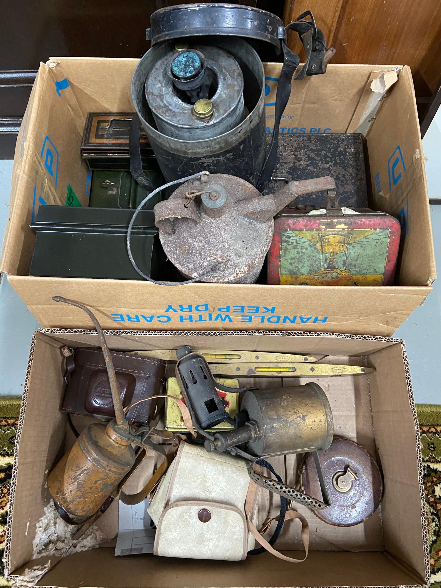 Two boxes of collectable stoves, cash boxes, Brass and wood spirit levels, Leather bound measure