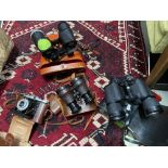 Three pairs of various binoculars with carry cases and vintage Nettar bellow camera. Makes on