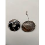 A Lot of two silver and agate brooches.