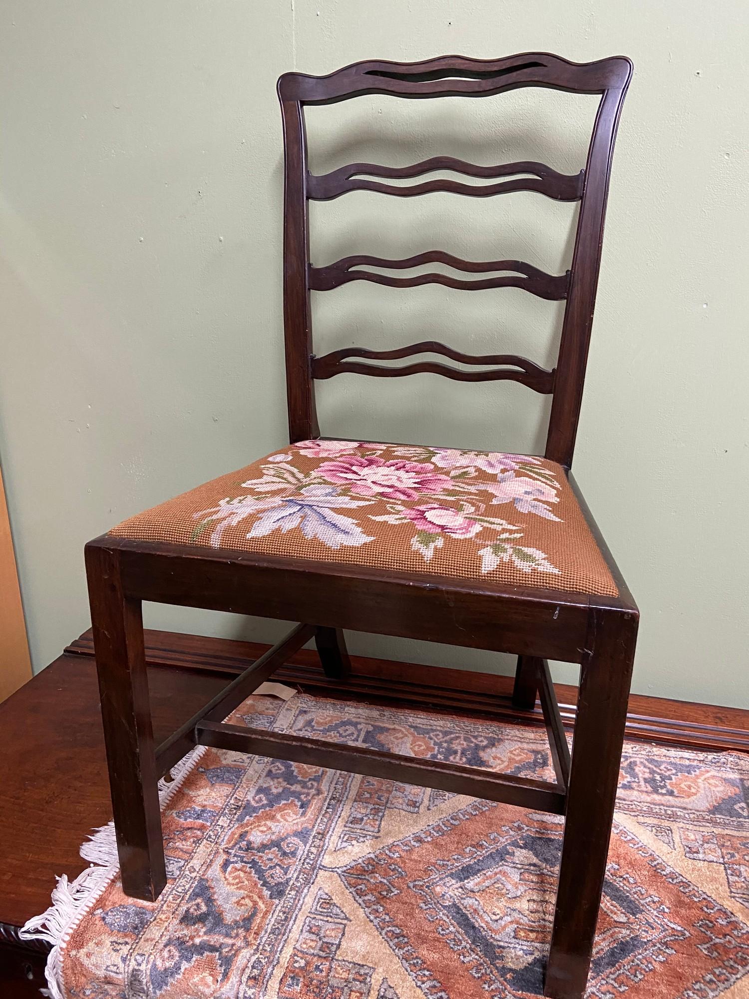 A Georgian ladder back farm house chair. designed with a tapestry topped seat area.