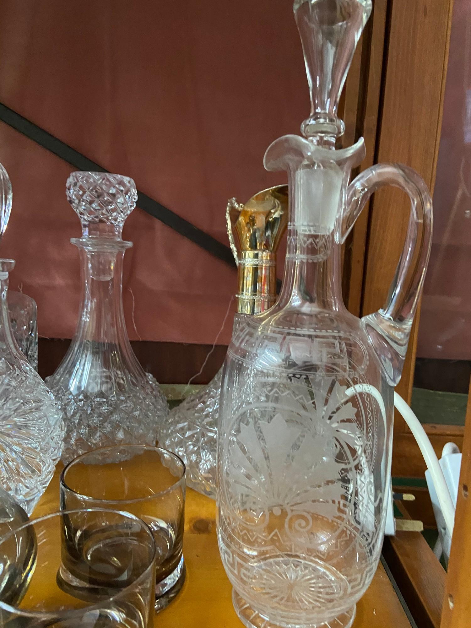 A Lot of vintage and antique cut crystal and glass decanters which includes smoked glass whisky - Image 4 of 6
