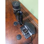 A Vintage Yashica TL-Super camera with fitted lens together with a large Soligor zoom lens with