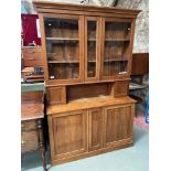 A Victorian stripped pine dresser. Designed with glass front doors. Comes with keys. [217x138x49cm]