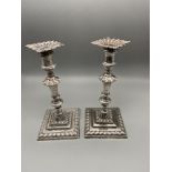 A Pair of ornate London silver candle sticks made by Johnson Walker & Tolhurst. Dated 1909. [16cm