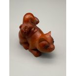 A Hand carved Japanese netsuke of a mouse on top of a cat. Signed by the artist. [5cm length]