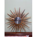 A Retro teak and metal Sunburst wall clock by Seth Thomas, Quartzmatic. [66cm diameter]