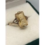 A Ladies mid 20th century 9ct gold ring set with a large rectangular faceted cut citrine stone. [