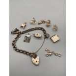 A London silver charm bracelet with an assortment of various silver charms.