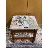A Vintage footstool, designed with a tapestry of Peter Rabbit. [38cm height]