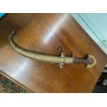 A Vintage Jambiya brass and wood dagger with sheath.