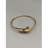 A Ladies vintage 9ct gold dolphin bangle. [Weighs 3.89Grams] [6.5cm diameter]