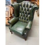 A Vintage Green leather chesterfield gull wing arm chair. Stressed green leather.