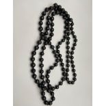 A Vintage ladies Jet bead necklace. Showing knots between each bead. [150cm length]