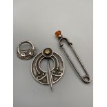 A Lot of three Scottish brooches and pins. Includes Silver Celtic design brooch, Citrine thistle