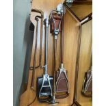 A Lot of three shooting stick stands and two various riding crops.